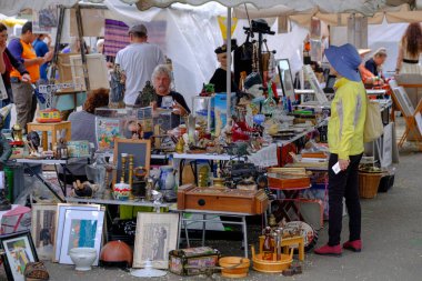 Adam bit pazarında eski antika şeyler satıyor.