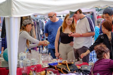 Adam bit pazarında eski antika şeyler satıyor.