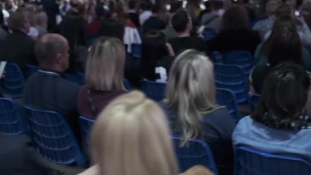 Business conference attendees sit and listen — Stock Video