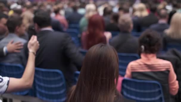 Business conference attendees sit and listen — Stock Video