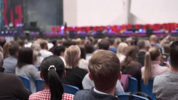 Business conference attendees sit and listen — Stock Video