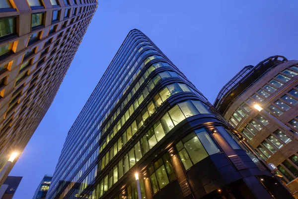 Illuminated modern building against evening sky — Stock Photo, Image