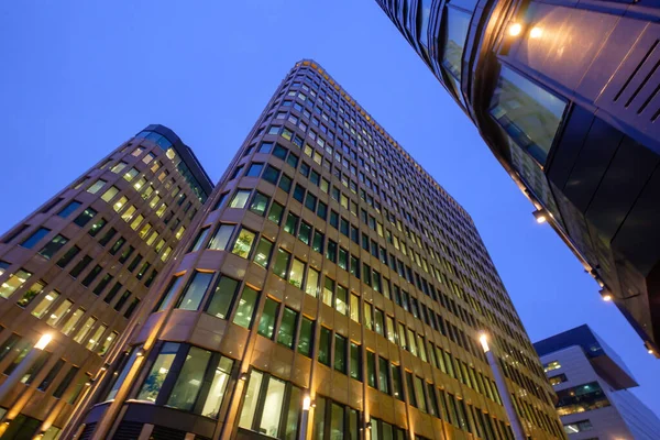 Illuminated modern building against evening sky — Stock Photo, Image