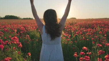 Çiçek açan çayırda tanınmayan, buruşuk saçlı bir kadın.