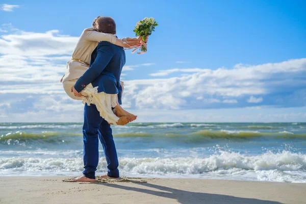 Unerkennbares Paar umarmt sich in der Nähe des winkenden Meeres — Stockfoto