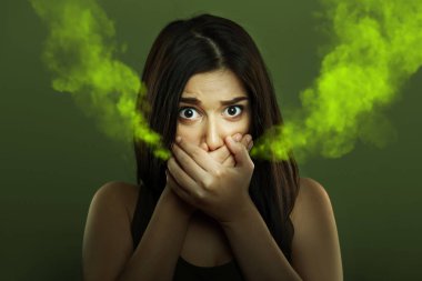 Halitosis concept of young woman with bad breath clipart