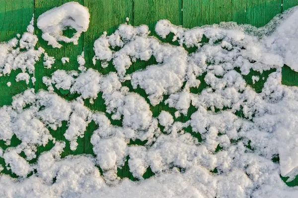 Hintergrund der grünen Bretter im Schnee — Stockfoto