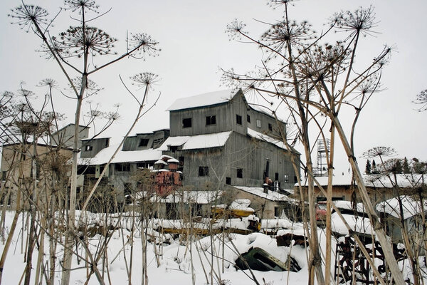 old granary covered with snow on a winter day