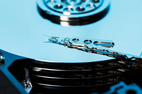 Disassembled hard drive from the computer, hdd with mirror effect. Opened hard drive from the computer hdd with mirror effects. Part of computer pc, laptop.