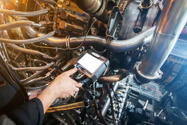 Inspection of a gas turbine engine using a Video Endoscope. Search for defects inside the turbine and shooting on video, photos using a measuring instrument. Copy-Space Video Endoscope. Gas turbine.