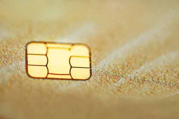 Gold credit card with micro chip selective focus. Macro shooting with a credit card. Selective focus microchip on paying by credit card or debit card for background. contactless payments