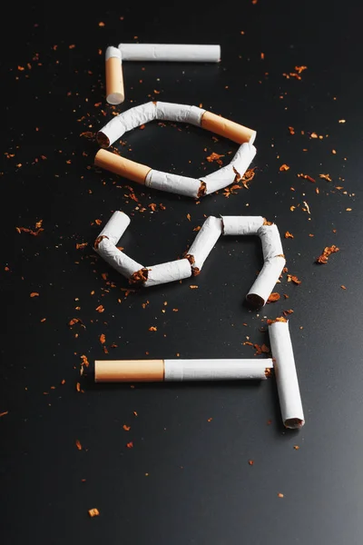 The inscription LOST from cigarettes on a black background. Stop smoking. The concept of smoking kills. Motivation inscription to quit smoking, unhealthy habit.