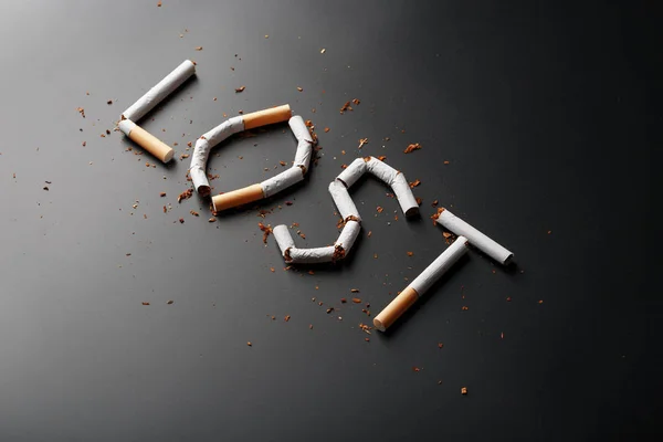 The inscription LOST from cigarettes on a black background. Stop smoking. The concept of smoking kills. Motivation inscription to quit smoking, unhealthy habit.