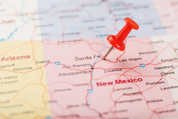 Red clerical needle on a map of USA, New Mexico and the capital of Santa Fe. Close up map of new mexico with red tack