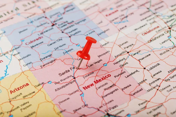 Red clerical needle on a map of USA, New Mexico and the capital of Santa Fe. Close up map of new mexico with red tack