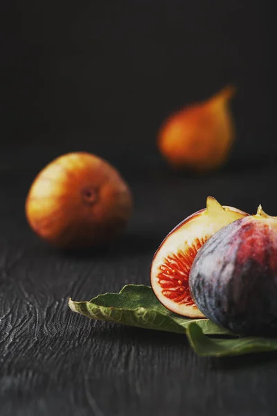 Figs on a dark background, fig flesh close-up. Still life from a group of fig fruits on a black substrate