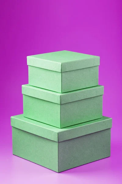 Boxes on a pink background in the form of a pyramid. Isolate