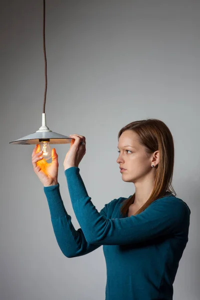 Young Woman Holding Illuminated Light Bulb Home — Stock Photo, Image