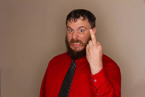 Бородатый мужчина делает грубый жест пальцем — стоковое фото