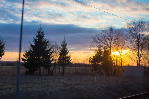 Train window view with dramatic sunset light