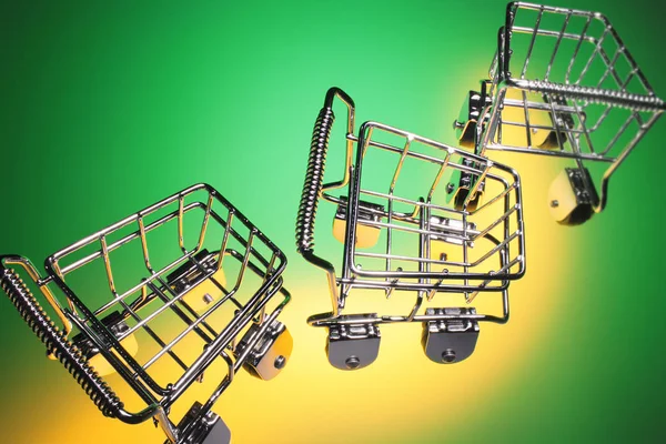 Miniature Shopping Trolleys Green Background — Stock Photo, Image