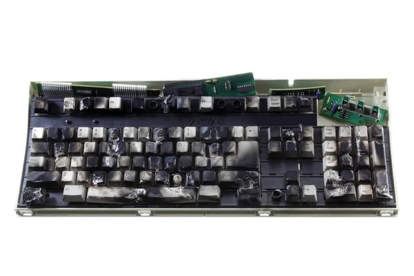白い背景の上の焦げたコンピューターのキーボード — ストック写真