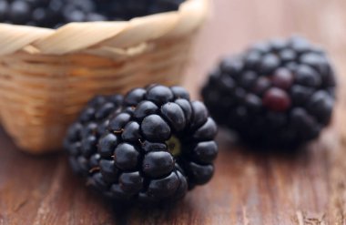 Sepet ile ahşap yüzeyde taze böğürtlen