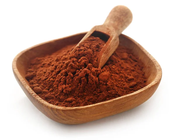 Cacao Powder in a bowl and scoop over white background