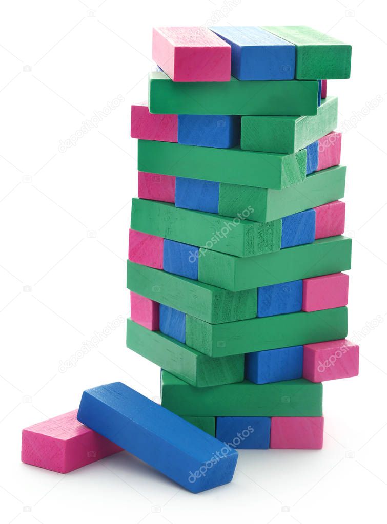 Jenga game of colorful wooden blocks constructed a tall building