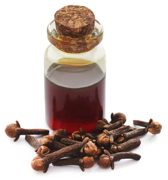 Fresh clove with oil in a jar — Stock Photo, Image