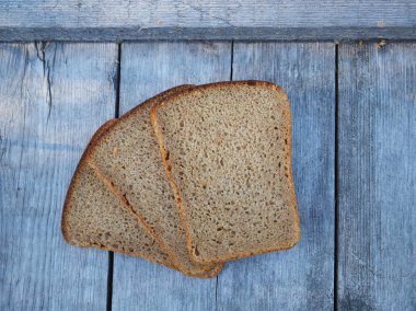 Tahta arka planda dilimlenmiş ekmek.