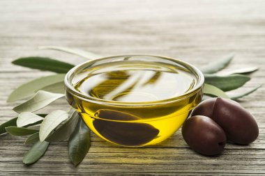 Ahşap arka plan üzerinde siyah zeytin ile zeytinyağı