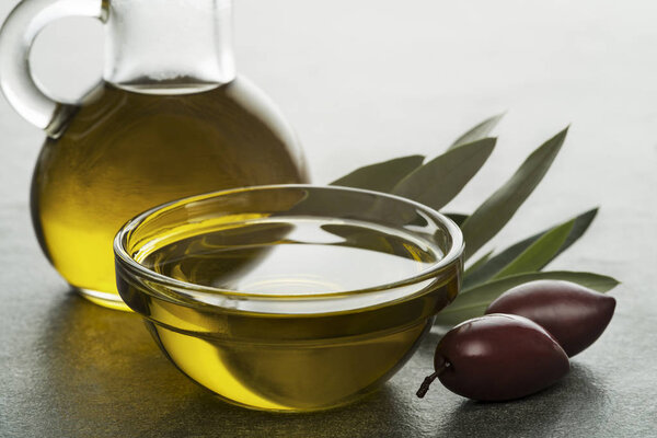 Bottle of Olive oil and olives close up
