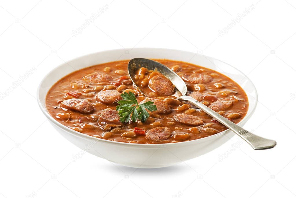 Baked beans stew with tomato sauce and sausage with herbs isolated on white