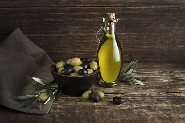 Bottle of Extra virgin healthy Olive oil with fresh olives close up