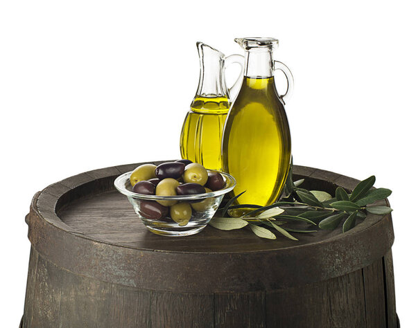 Bottle of Extra virgin healthy Olive oil on wooden barrel background isolated on white