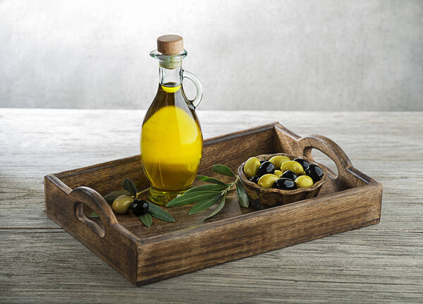 Bottle of Extra virgin healthy Olive oil with fresh olives. Concept of nature and healthy food