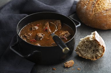 Portion of traditional Beef stew - goulash with bread clipart