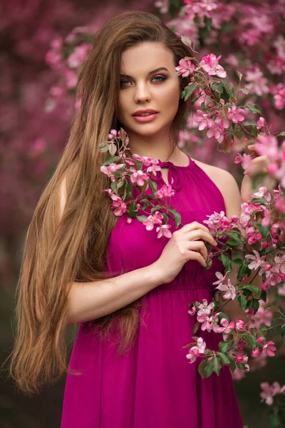 Romantiskt porträtt av ung vacker kvinna i blommande rosa äppel trädgård — Stockfoto