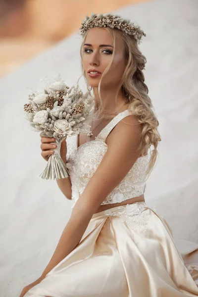 Retrato de novia hermosa está usando vestido de vuelo de moda y corona en el gran desierto de Dubai . — Foto de Stock