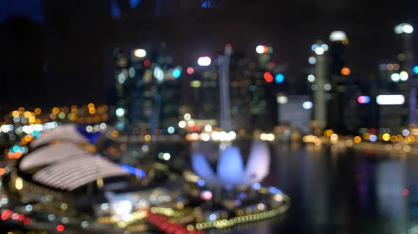 Abstract blurred light with office building and reflection night view on Singapore