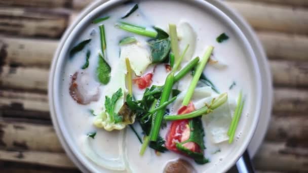 Top of view of spicy coconut Thai soup on a wooden table. 1920x1080 — Stock Footage Top of view of spicy coconut Thai soup on a wooden table. 1920x1080 Stock Video