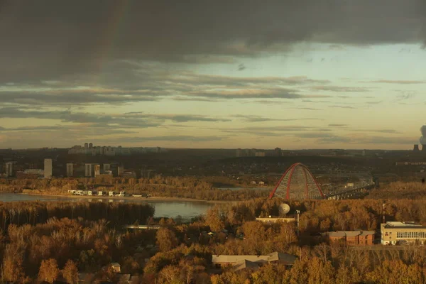 Bugrinsky bridge over the Ob river in Novosibirsk against cloudy sky with a bright rainbow — Stock Image Bugrinsky bridge over the Ob river in Novosibirsk against cloudy sky with a bright rainbow Stock Image