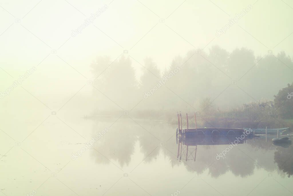 Misty lake in a early  morning landscape