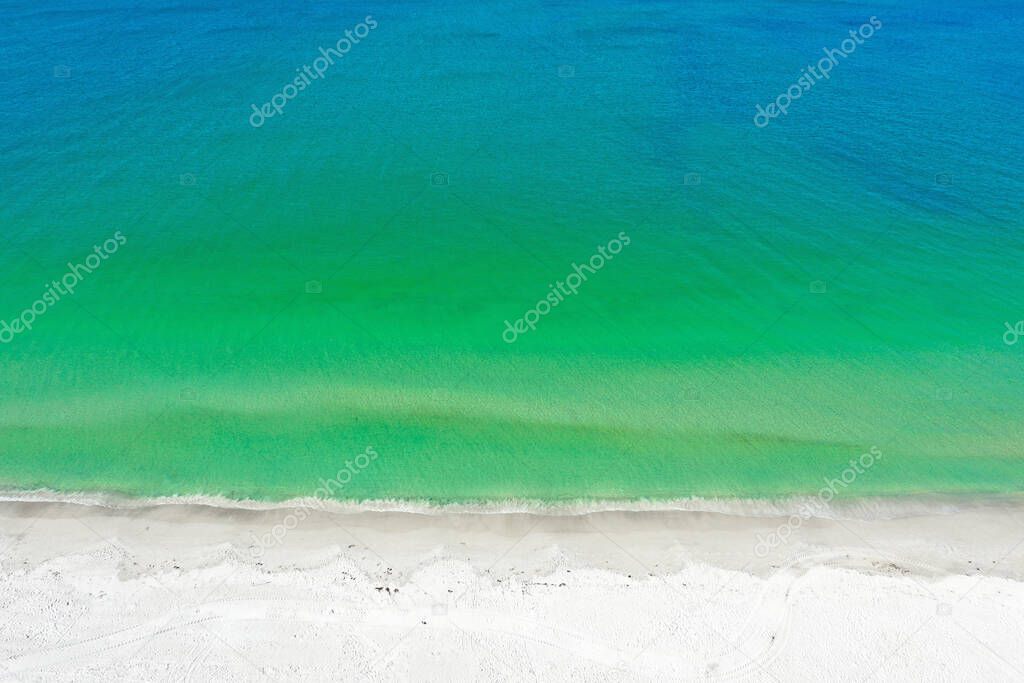 Aerial Photo of the Beach of Anna Maria Island with the Ocean Surf Coming Ashore.