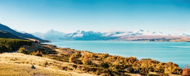Road to Mt Cook, the highest mountain in New Zealand. Scenic highway drive along Lake Pukaki in Aoraki Mt Cook National Park, South Island of New Zealand. clipart