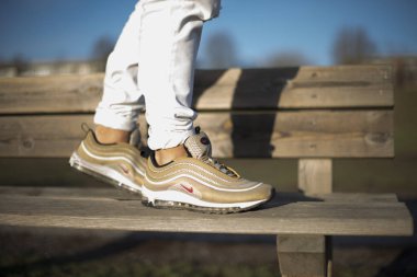 Pavia, Italy - December 13, 2017: Nike Air Max 97 Gold shoes in the street