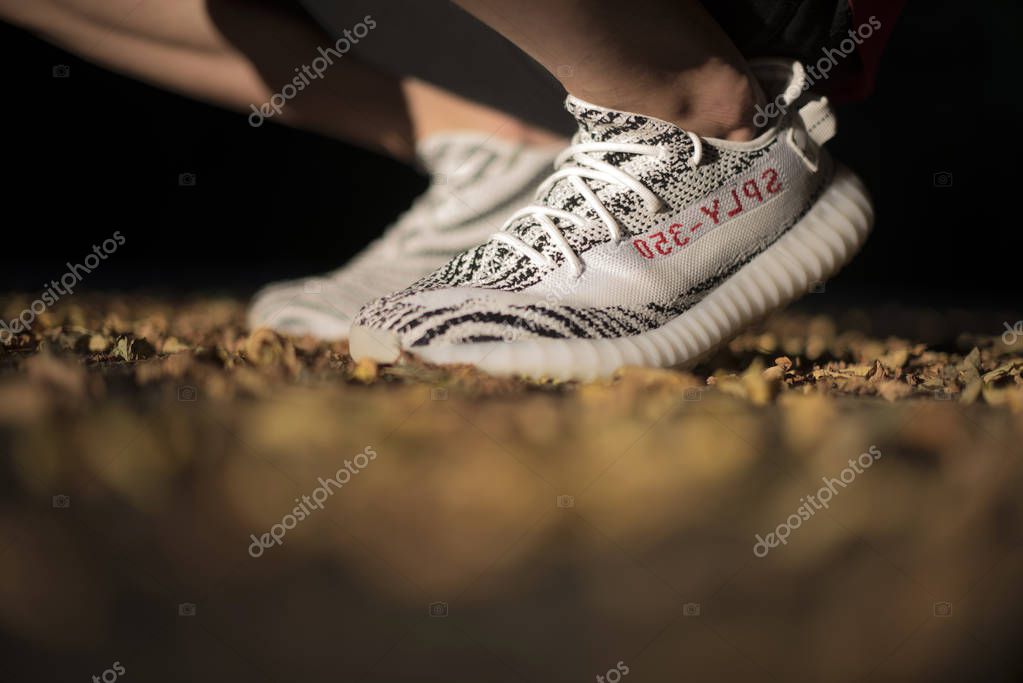 Milan, Italy - July 08, 2018: Man wearing a pair of Adidas Yeezy in the street