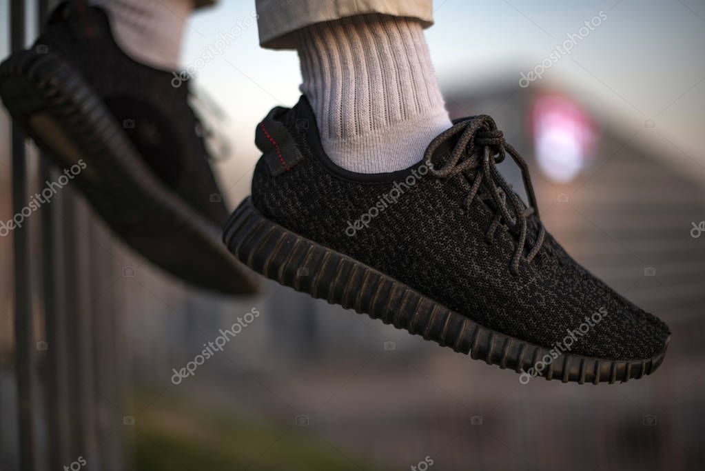 Milan, Italy - December 15, 2018: Young man wearing Vans Old Skool shoes in the street - illustrative editorial