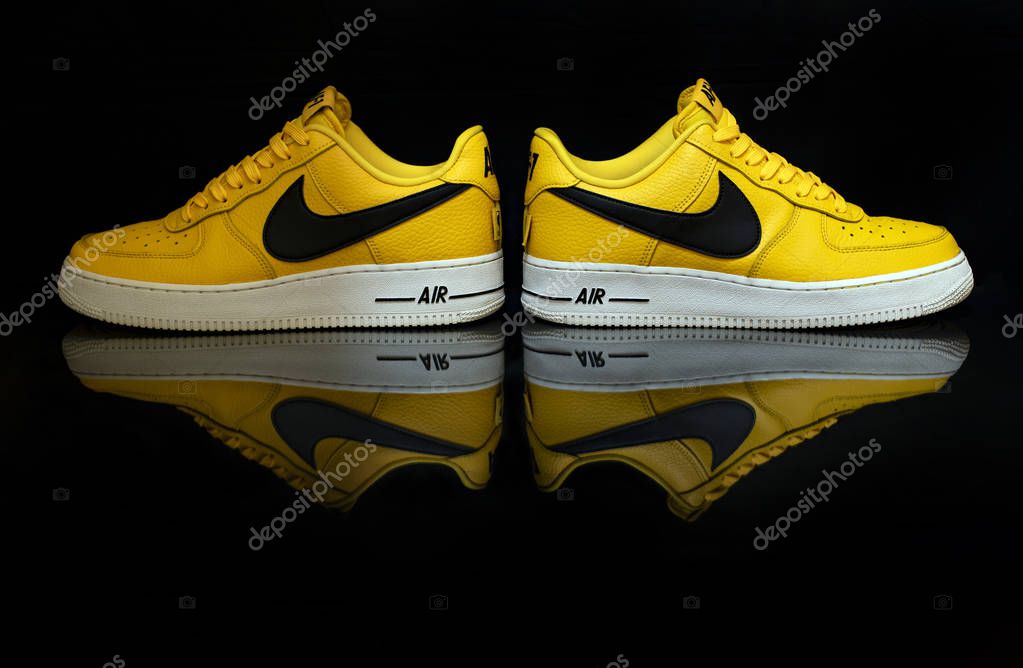 Pavia, Italy - June 22, 2019:  Nike Air Force One '07 shoe studio portrait on black background with reflection - illustrative editorial